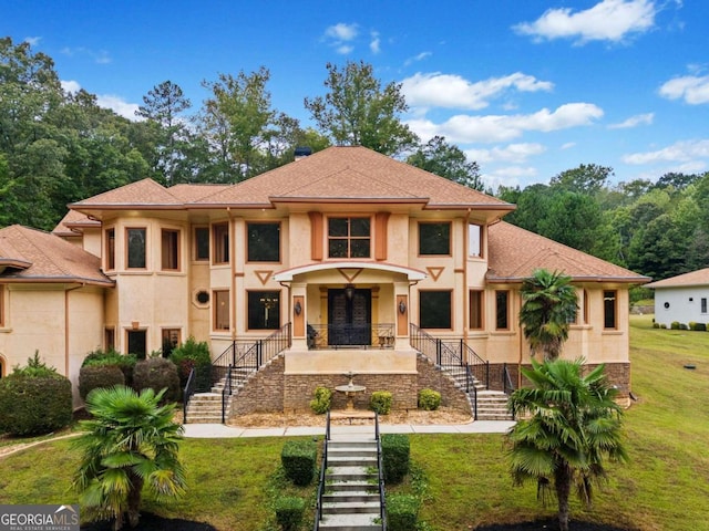 rear view of property featuring a lawn and covered porch