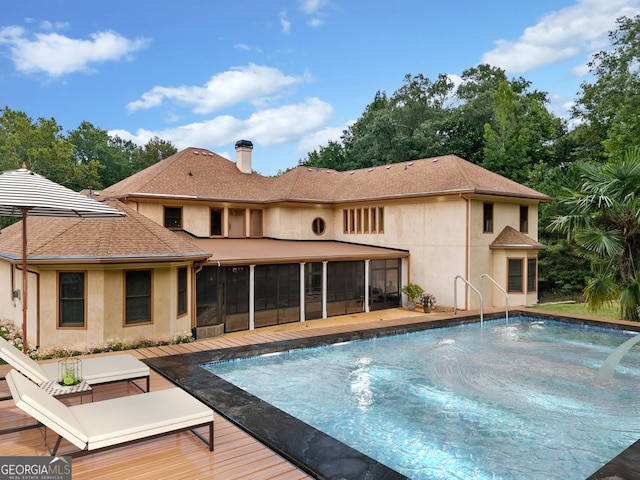 view of swimming pool featuring a sunroom