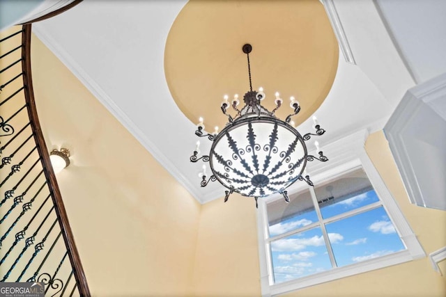 interior details with ornamental molding and a chandelier