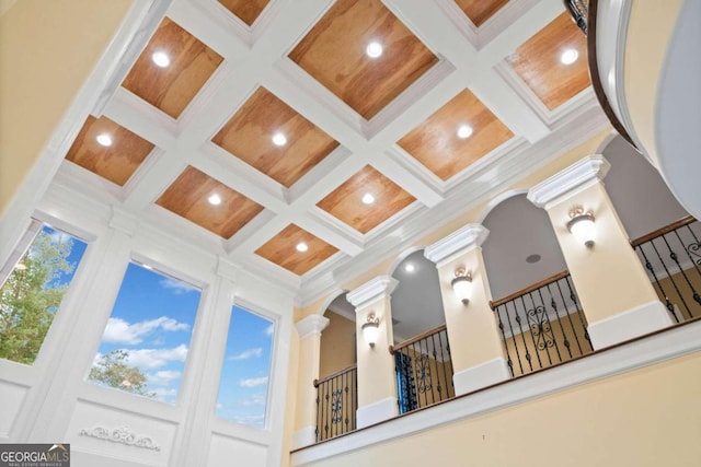 room details featuring ornate columns, beam ceiling, coffered ceiling, and crown molding