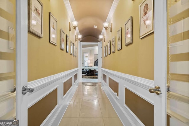 hall featuring crown molding and light tile patterned floors