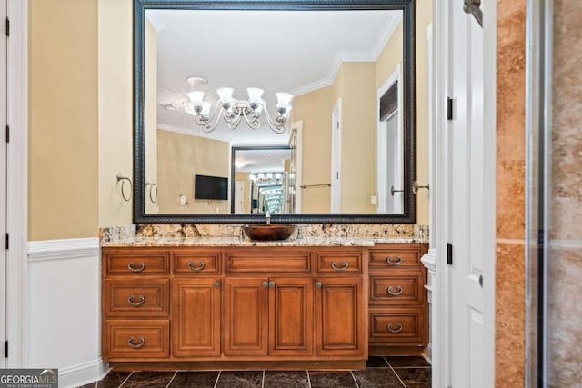 bathroom with a chandelier, toilet, vanity, and crown molding