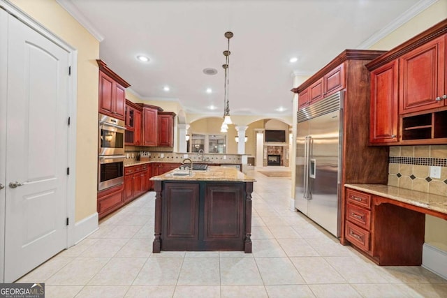 kitchen with appliances with stainless steel finishes, hanging light fixtures, ornamental molding, and tasteful backsplash