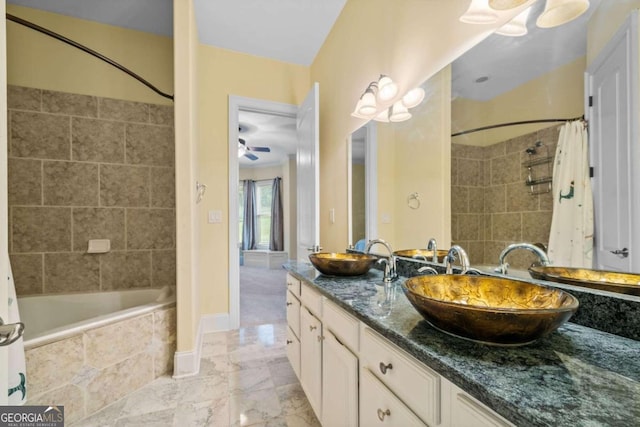 bathroom featuring shower / tub combo, vanity, and ceiling fan