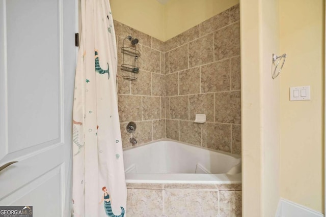 bathroom with shower / bathtub combination with curtain