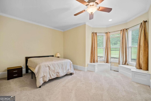 carpeted bedroom featuring ornamental molding and ceiling fan