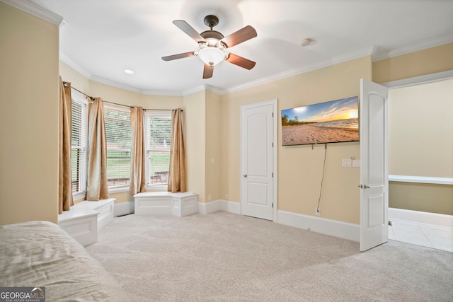 interior space with ceiling fan, light carpet, and crown molding