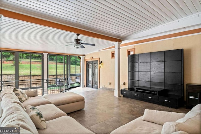 tiled living room with ceiling fan, wood ceiling, and plenty of natural light