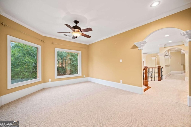 carpeted empty room featuring ceiling fan and crown molding