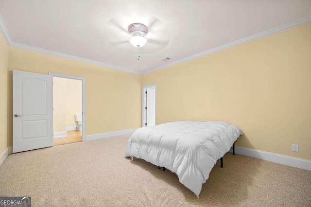 carpeted bedroom featuring ceiling fan, ensuite bathroom, and crown molding