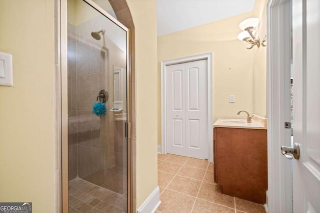 bathroom featuring vanity, tile patterned floors, and a shower with shower door