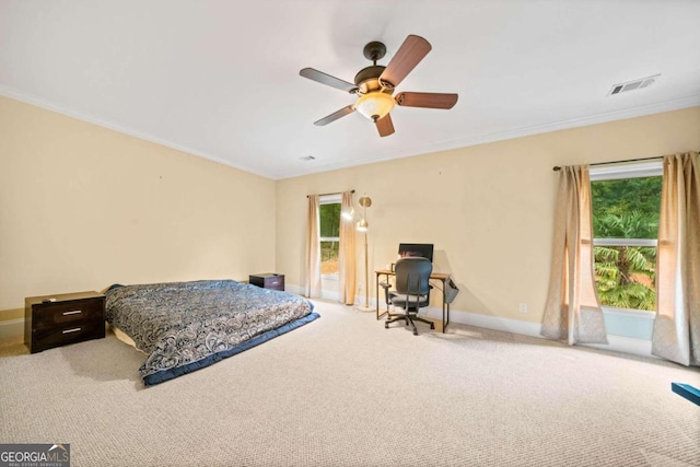 carpeted bedroom featuring ceiling fan and ornamental molding