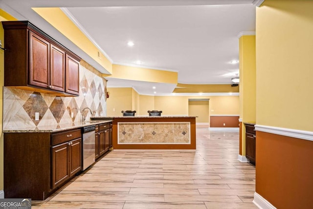 kitchen with crown molding, kitchen peninsula, light stone countertops, and light hardwood / wood-style flooring