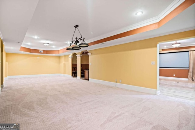 basement featuring ornamental molding, light carpet, and a chandelier