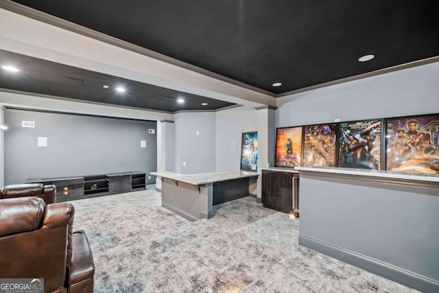 carpeted cinema room with crown molding