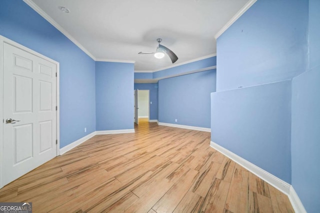 spare room with light wood-type flooring, crown molding, and ceiling fan