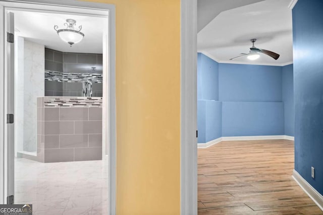 interior space with ornamental molding, hardwood / wood-style floors, and ceiling fan