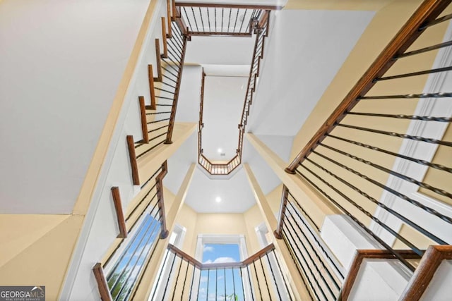 stairs featuring a towering ceiling