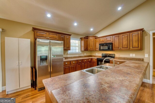 unfurnished living room with vaulted ceiling, ceiling fan, and light hardwood / wood-style floors