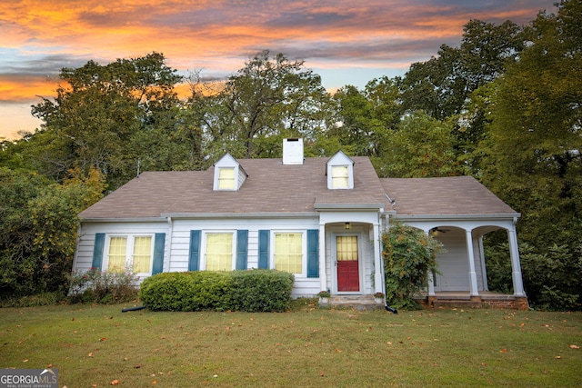 new england style home with a lawn