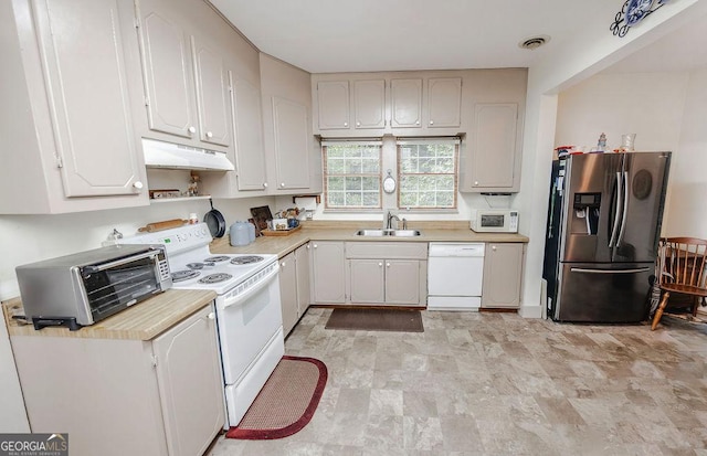 kitchen featuring white appliances, white cabinetry, and sink