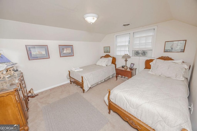 bedroom with light carpet and lofted ceiling