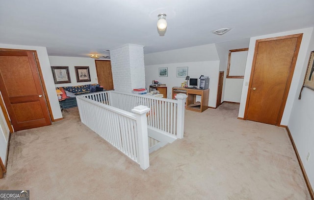 hallway featuring light colored carpet