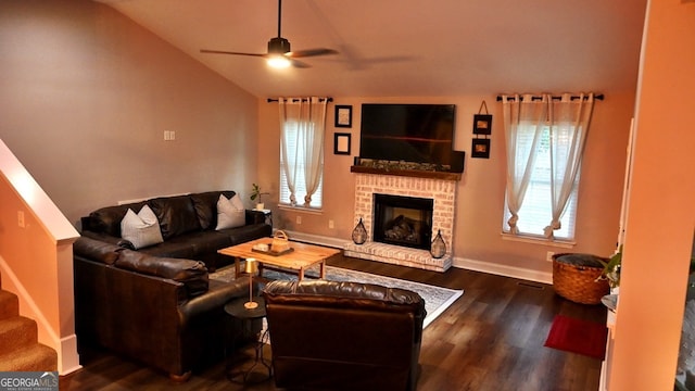 living room with lofted ceiling, ceiling fan, a fireplace, and dark hardwood / wood-style flooring