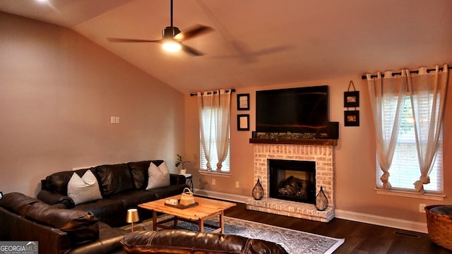 living room featuring lofted ceiling, plenty of natural light, ceiling fan, and a fireplace