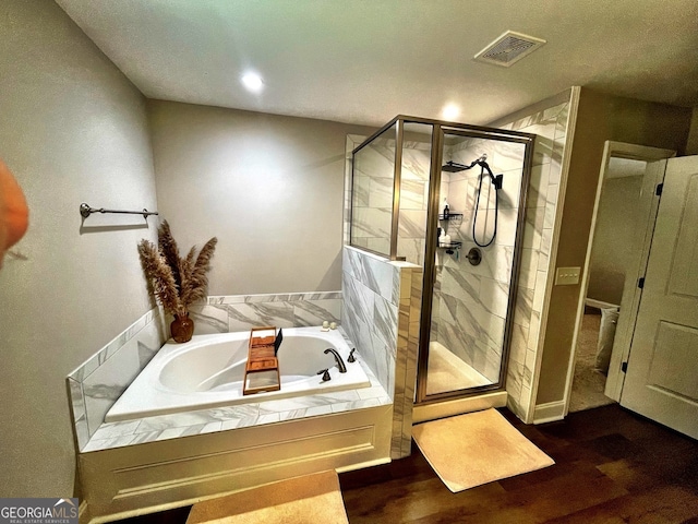 bathroom with hardwood / wood-style floors and plus walk in shower