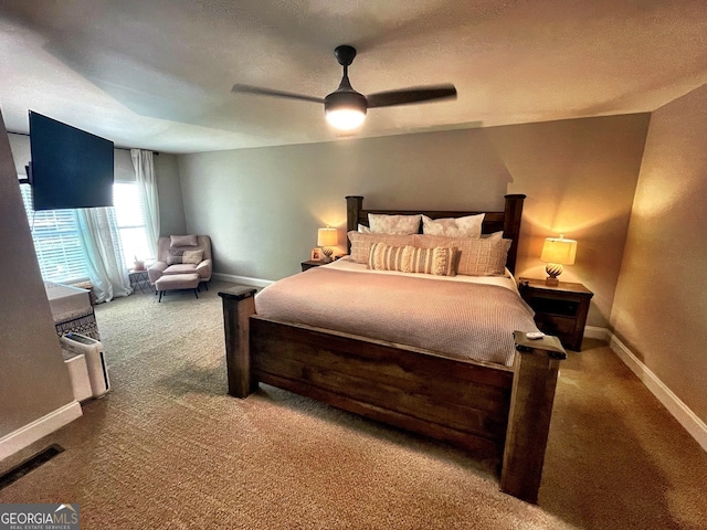 carpeted bedroom featuring a textured ceiling and ceiling fan