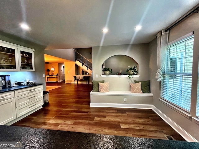 interior space featuring a textured ceiling, dark hardwood / wood-style floors, and white cabinets