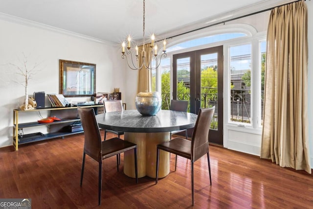 dining room featuring ornamental molding, dark hardwood / wood-style flooring, and a chandelier