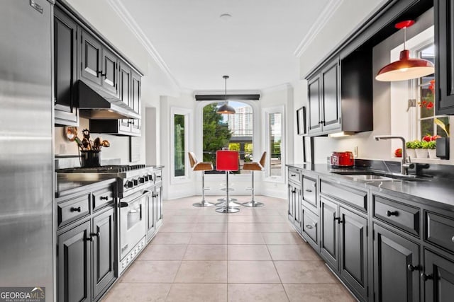 kitchen featuring light tile patterned floors, crown molding, appliances with stainless steel finishes, sink, and pendant lighting