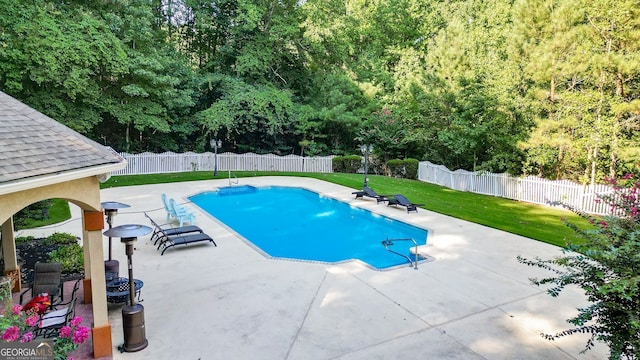 view of swimming pool with a patio area and a lawn