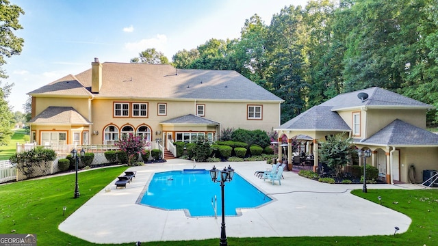 view of swimming pool with a patio area and a yard