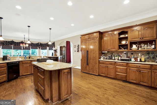 kitchen with a kitchen island, tasteful backsplash, hanging light fixtures, ornamental molding, and hardwood / wood-style flooring