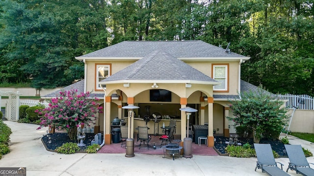 view of front of home with a bar and a patio