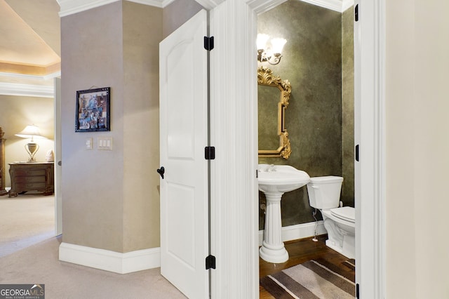 bathroom with toilet and crown molding