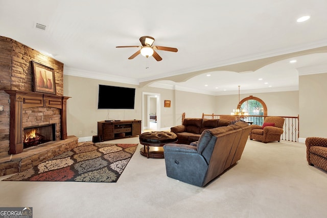 carpeted living room featuring ceiling fan with notable chandelier, ornamental molding, and a fireplace