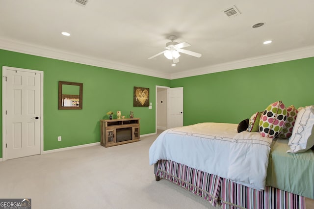 carpeted bedroom featuring ceiling fan and crown molding