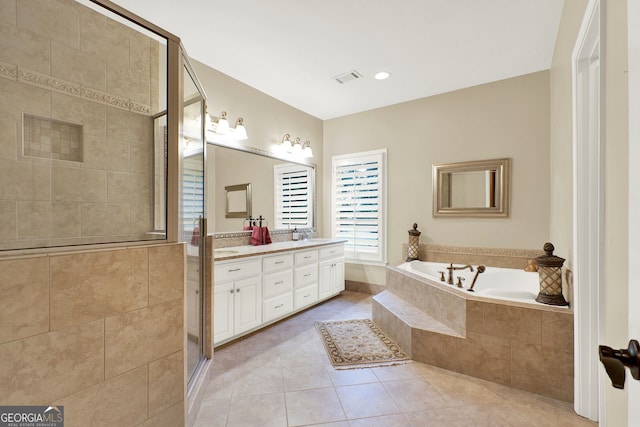 bathroom with shower with separate bathtub, vanity, and tile patterned flooring