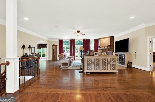 living room featuring ceiling fan, dark hardwood / wood-style floors, and crown molding