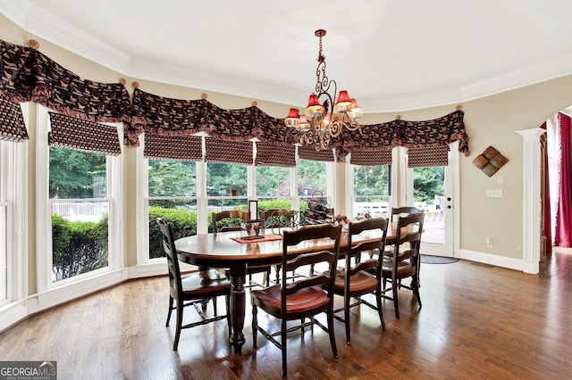 dining room featuring ornamental molding, a chandelier, and dark hardwood / wood-style flooring