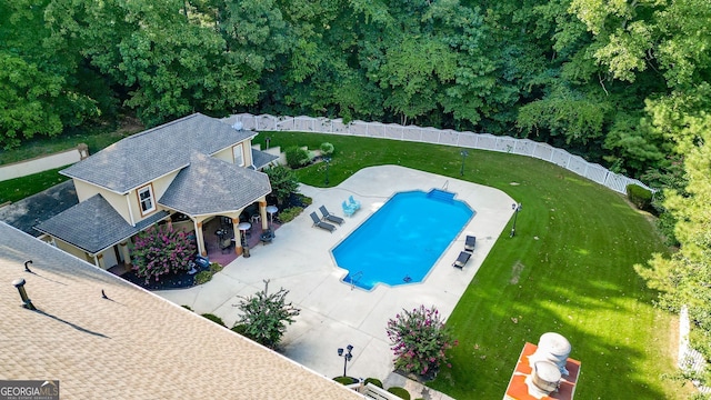 view of pool with a yard and a patio