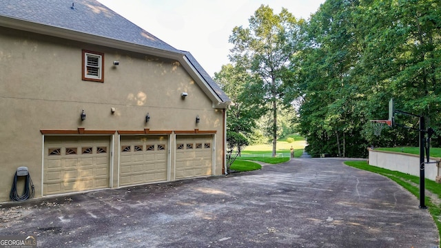 view of side of home featuring a garage