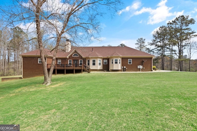 view of front of home with a front yard and a deck