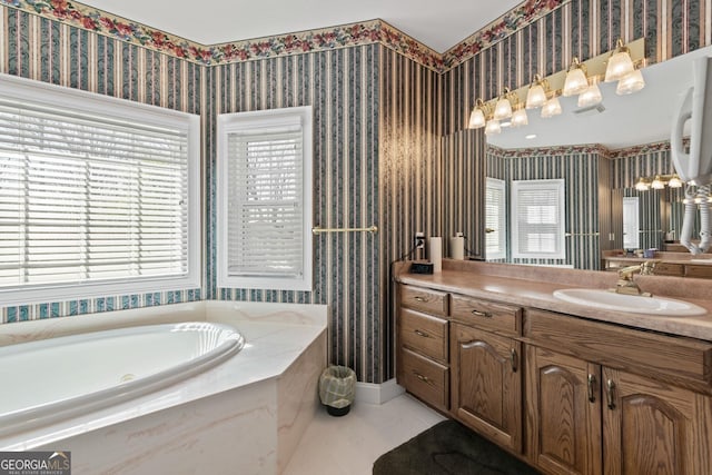 bathroom featuring tile patterned floors, tiled tub, and vanity