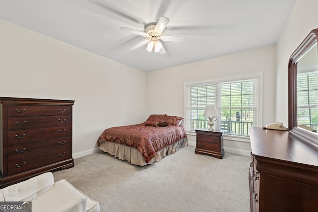 bedroom with ceiling fan and light carpet