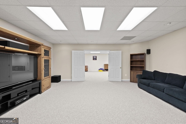 carpeted living room featuring a paneled ceiling